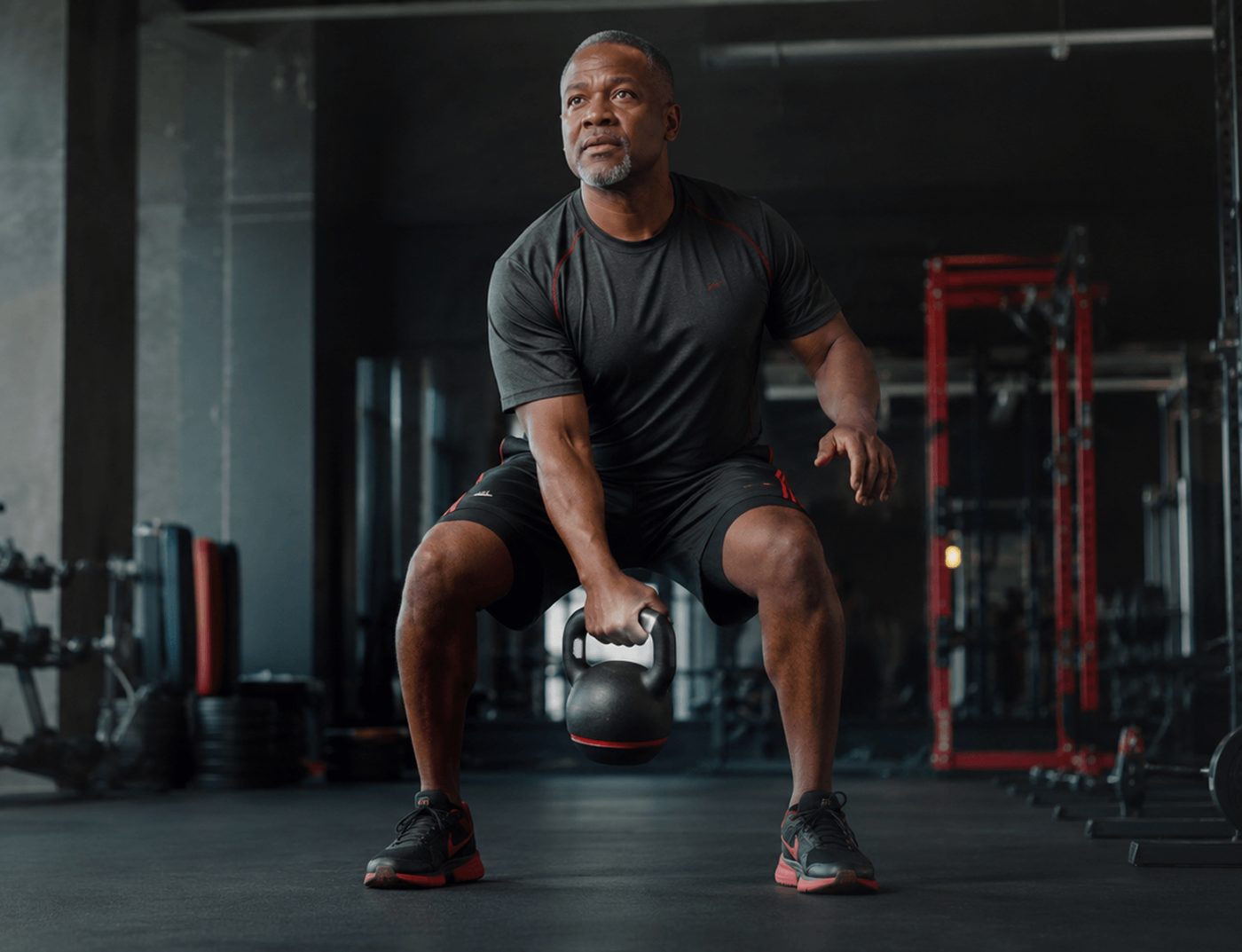 Adult training with a kettlebell in a gym